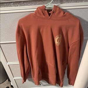 Rust Orange Hooded Sweatshirt with Gold Crest